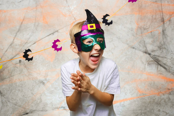 the child in the mask is surprised on Halloween - Photo, Image