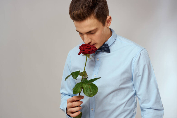 romantic man with red rose and light shirt pants suit - Foto, Imagen