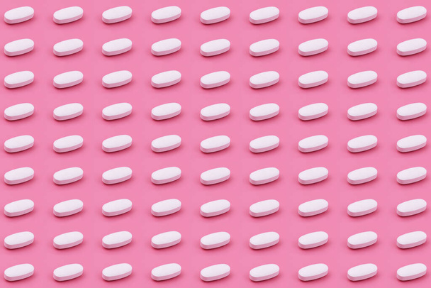 White Pharmaceutical medicine tablet on a pink background,Medicine creative concepts. Minimal style with colorful paper backdrop.Trendy colors,Trendy pattern - Foto, Imagen