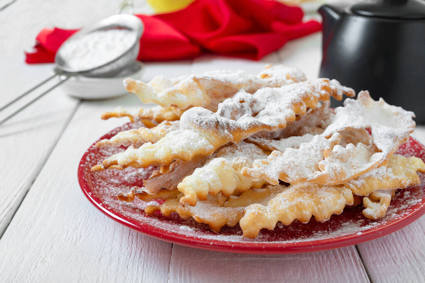Brushwood - crispy deep fried cookies in powdered sugar with tea and jam. A traditional treat at European festivals. - Photo, Image