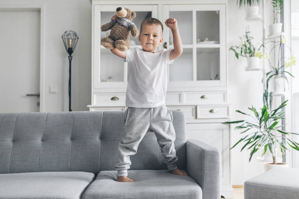 Cute child at home on sofa in the living room - Foto, Bild