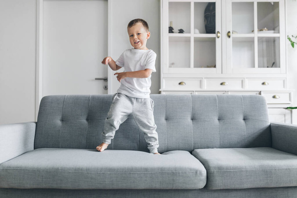 Cute child at home on sofa in the living room - Foto, Imagem