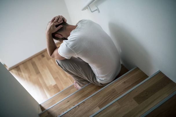 Depressed young man at home worried about finances - Valokuva, kuva