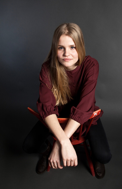 Scandinavian cute young girl sitting on a chair - Photo, Image