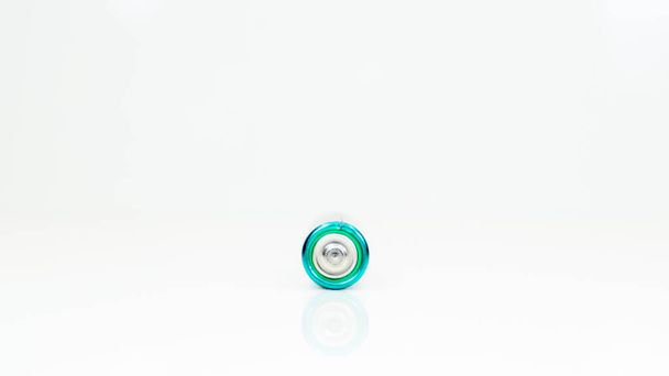 One alkaline battery on a white background with reflection. Energy supply and recycling concept. Copy space. Minimalism. Eliment AA is the most common type of galvanic batteries and accumulators - Photo, Image
