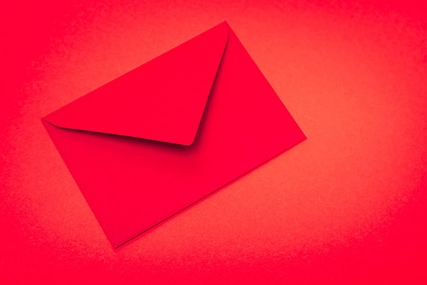 top view of envelope on red background - Foto, Imagen