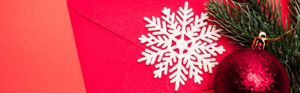 top view of Christmas decoration and envelope on red background, banner - Photo, Image