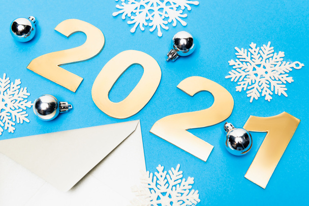 new year decoration, envelope and 2021 numbers on blue background - Photo, Image