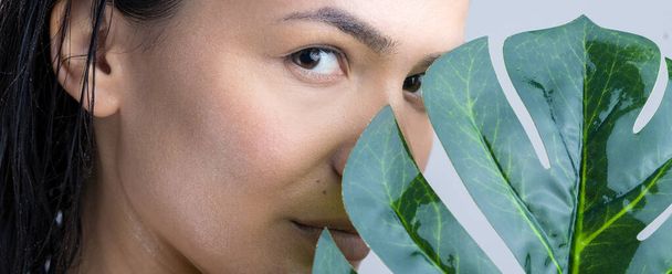 Beauty Woman with natural green palm leaf portrait. Fashion, beauty, make-up, cosmetics. - Fotó, kép