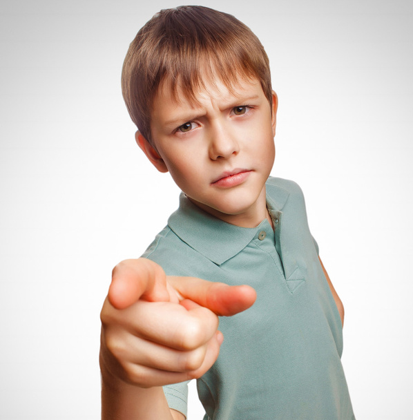 Angry kid boy shows his finger to screen evil is isolated on a w - Photo, Image