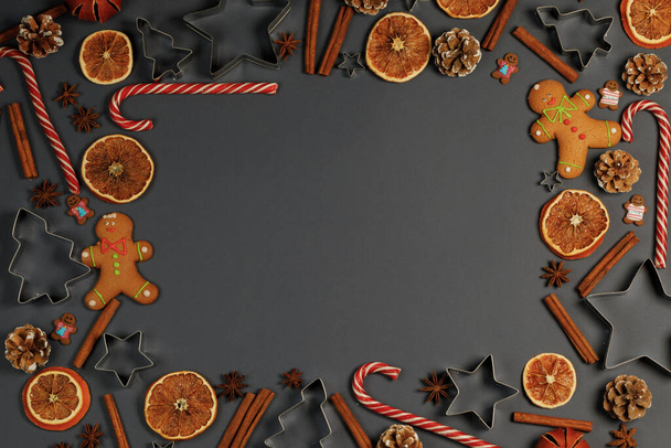 Christmas food frame. Gingerbread cookies, spices and decorations on gray background with copy space - Valokuva, kuva