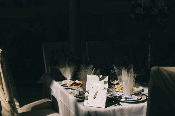 Table number seven. Interior of restaurant for wedding dinner, ready for guests. - Fotó, kép