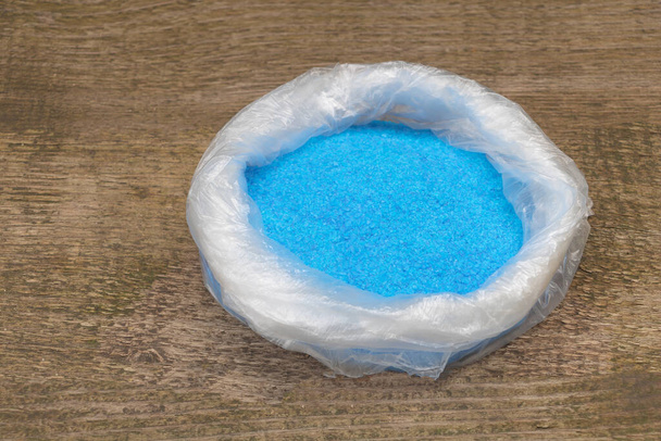 Copper Sulphate Crystals in a bag, Wooden background - Photo, Image