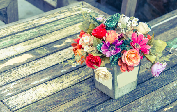 Vintage flower of the fabric on wood table. - Фото, изображение