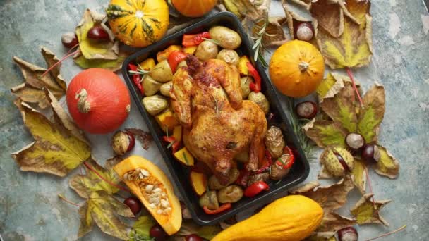 Roasted chicken or turkey garnished with pumpkins, pepper and potatoes. Served on a rustic table - Footage, Video