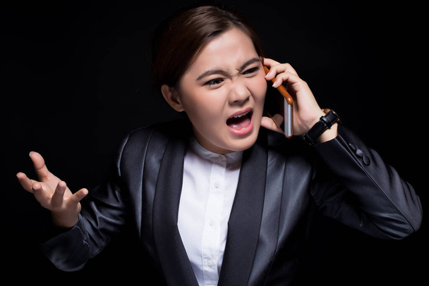 Woman calling the smartphone and she feel angry - Фото, зображення