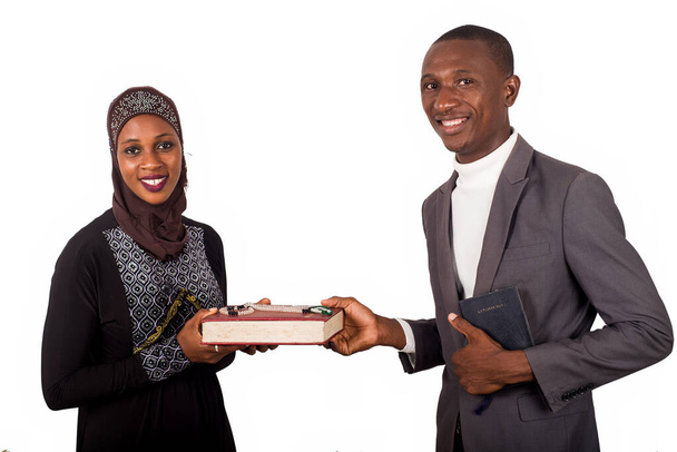 portraits of two smiling religious people holding a book on white background and looking at the camera - Photo, Image