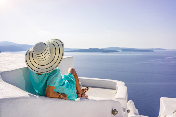 Woman on holidays in Santorini island in Greece - Photo, Image