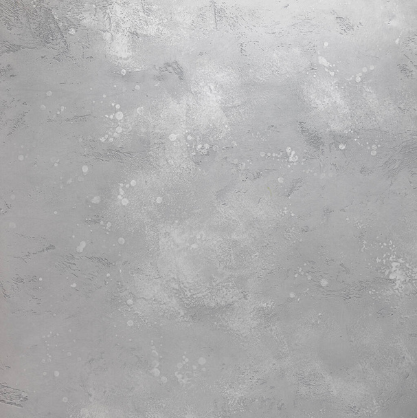 Empty handmade background made of cement or plaster painted in shades of gray color. Surface has textured scratches, spots and stains. - Photo, Image