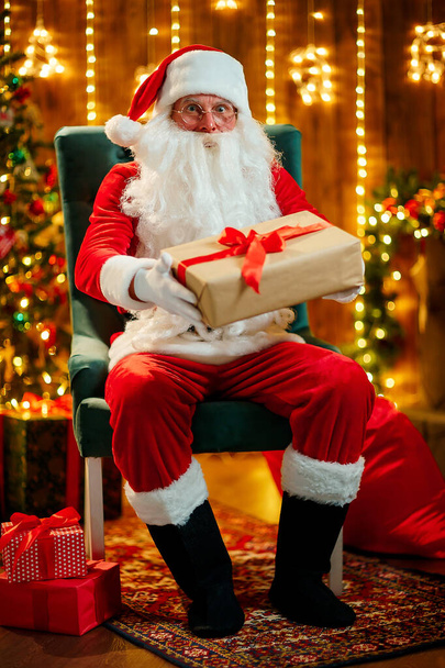 Photo of happy Santa Claus outdoors holding gift box for children - Φωτογραφία, εικόνα