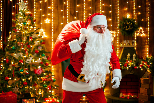 Santa Claus carrying presents in his sack - Photo, image
