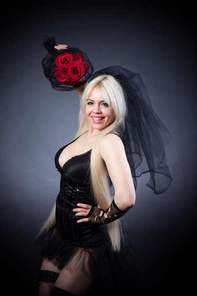 Portrait of a woman in black with flowers - Фото, зображення
