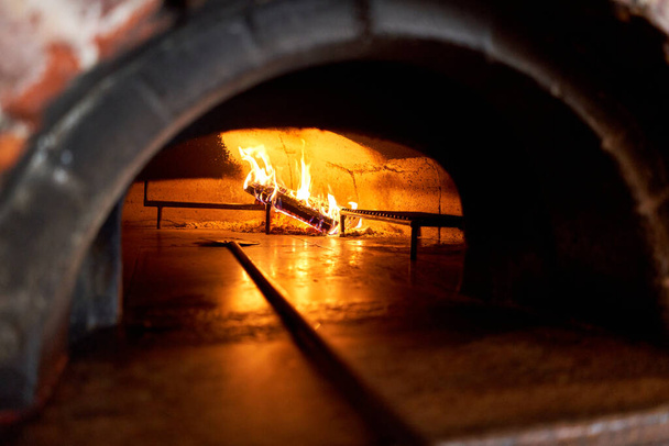 Traditional wood oven in Naples restaurant, Italy. Original neapolitan pizza. Red hot coal. Baked tasty pizza - Photo, Image