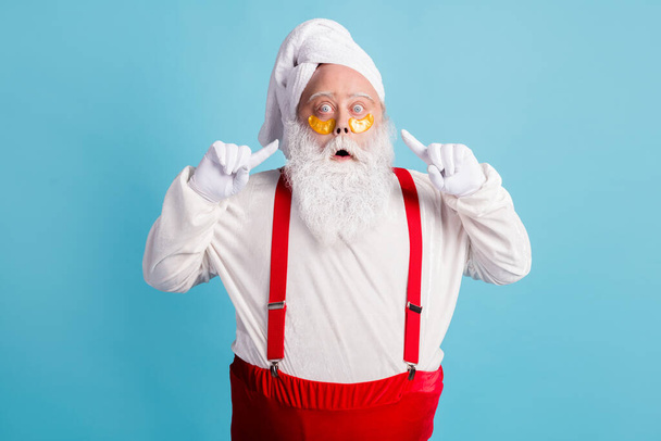 Photo of retired old man grey beard direct finger face excited look unexpected effect patch under eye wear santa x-mas costume towel turban suspender sunglass isolated blue color background - Foto, Imagen