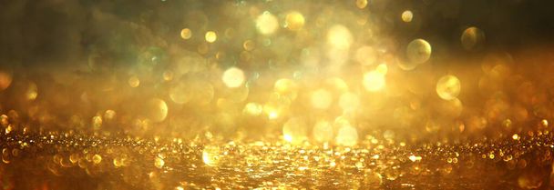 background of abstract gold and black glitter lights. defocused - 写真・画像