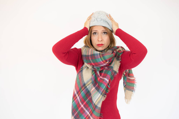 Happy Young Beautiful Woman in winter clothes worried on white background with copy space. - Photo, Image