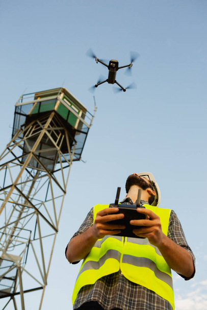 Drone operator piloting a Drone In A Rural Setting - Photo, Image