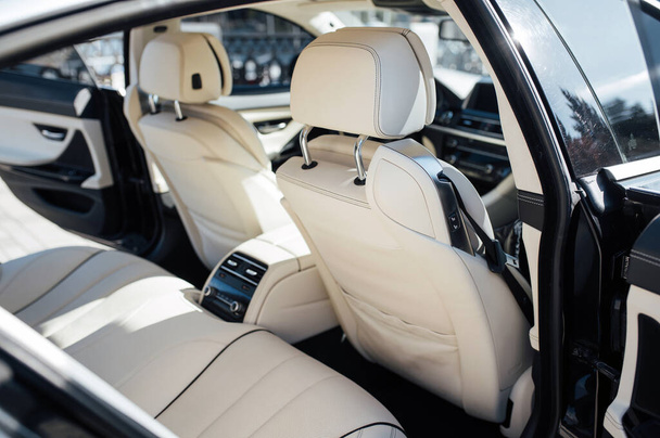 The back seat of a premium car. Beige leather and control system - Фото, зображення