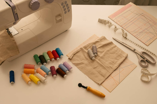 top view  flat lay sewing supplies, still life with sewing machine, patterns and threads - Valokuva, kuva