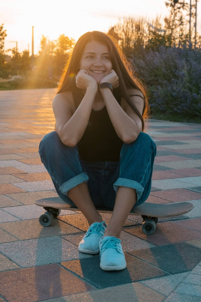 beautiful young woman with skateboard summer portrait - Photo, Image