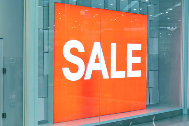 Advertising signboard inscription sale orange color in store in mall - 写真・画像