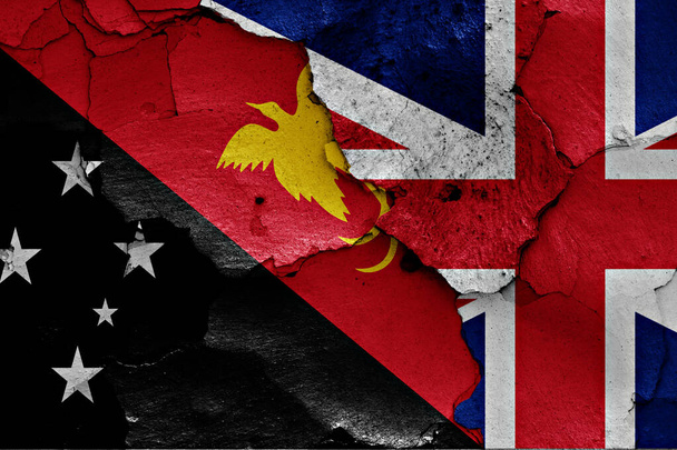 flags of Papua New Guinea and UK painted on cracked wall - Photo, Image