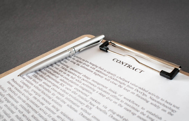 Pen and contract papers on wooden desk - 写真・画像