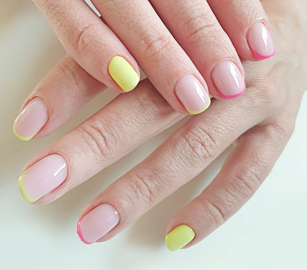  female hand beautiful manicure on a colored background - Φωτογραφία, εικόνα