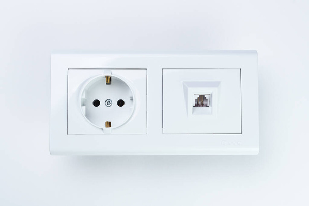 Belarus, Minsk - 05/12/2020: White Makel outlet on a white background.An electrical outlet and a white telephone socket Makel are located side by side on a white background. - Foto, Bild