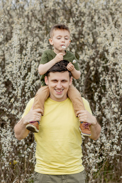 Image of happy man holding his son while having fun. - Foto, Imagem