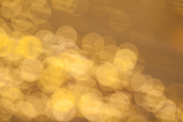 Golden bokeh background with glowing backdrop baubles - Photo, image