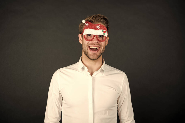 Santa claus coming. Winter holidays. Corporate party. Guy celebrate new year. Cheerful ideas for holidays celebration. Happy holidays. Merry christmas. Man white shirt posing with photo booth props - Φωτογραφία, εικόνα