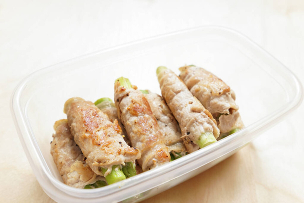 meat sausages with celery in plastic container - Photo, Image