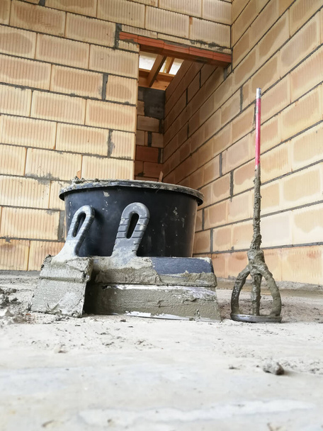 Taping knifes and cement bucket(construction work tools) for constructions at construction site - Photo, Image