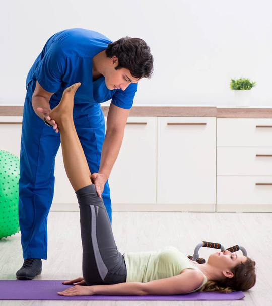 Fitness instructor helping sportsman during exercise - Fotó, kép