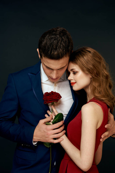 Beautiful couple charm hug lifestyle relationship rose luxury dark background - Foto, imagen