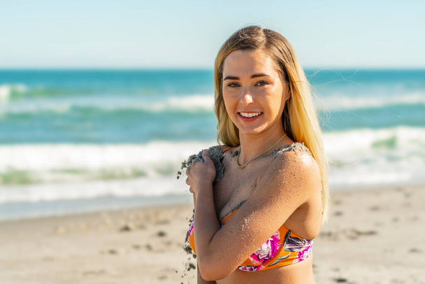 A gorgeous bikini model posing in a beach environment - Photo, image