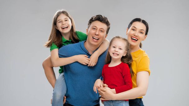 Happy loving family. Mother, father and children daughters on white background.  - Foto, Bild