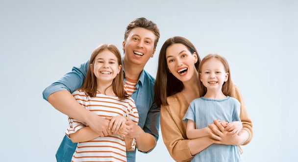 Happy loving family. Mother, father and children daughters on white background.  - Photo, image
