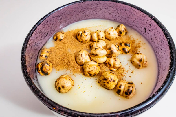 traditional turkish drink boza in glass with cinnamon powder and roasted chickpeas - Photo, Image